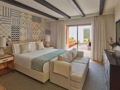 a swimming pool with lounge chairs and a swimming pool at Viceroy at Ombria Algarve in Loulé
