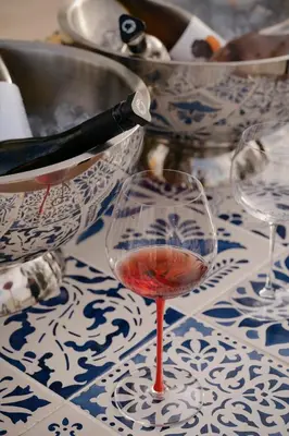 a restaurant with wooden tables and chairs and a kitchen at Viceroy at Ombria Algarve in Loulé