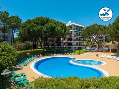 a swimming pool with lounge chairs and a building at Apartment Santa Monica by Algarve Vacation in Albufeira