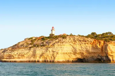 a lighthouse on an island in the water at Apartment Santa Monica by Algarve Vacation in Albufeira