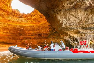 a group of people on a boat in front of a cave at Apartment Santa Monica by Algarve Vacation in Albufeira