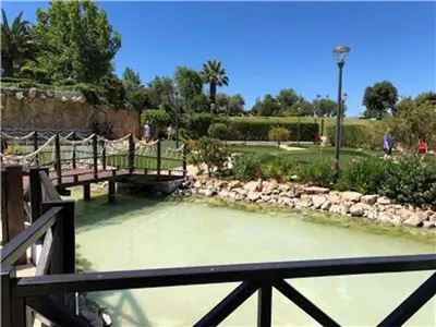 a view of a pond with benches in a park at Perfect ApartHotel Apartments 1 Bedroom in Albufeira