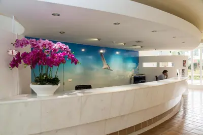 a lobby with a vase of purple flowers on a counter at Perfect ApartHotel Apartments 1 Bedroom in Albufeira