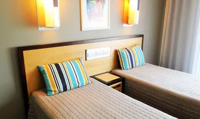 two beds in a small room with two at Exciting Albufeira Studio in Albufeira