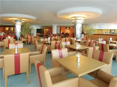 a restaurant with tables and chairs in a room at Exciting Albufeira Studio in Albufeira