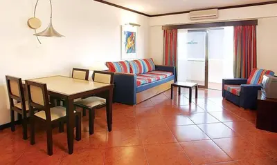 a living room with a couch and a table at Spectacular Albufeira 2 Bedroom apartment in the city center in Albufeira
