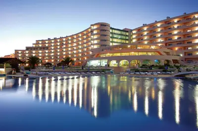 a large building with a pool of water in front of it at Spectacular Albufeira 2 Bedroom apartment in the city center in Albufeira