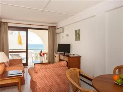 a living room with a dining room table with a view of the ocean at Fantastic Apartments 1 Bedroom in Olhos de Água