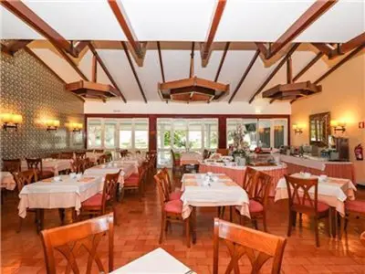 a restaurant with tables and chairs in a room at Brilliant Apartments 1 Beedroom in Quarteira