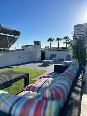 a group of chairs sitting on top of a roof at Beach Side Apartment in Albufeira