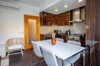 a kitchen with a white table and chairs at Sun & salt Apartment in Albufeira