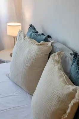a group of pillows on a bed with a lamp at Sun & salt Apartment in Albufeira