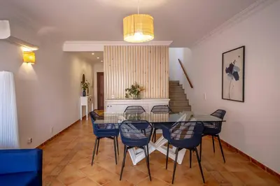 a living room with a chair and a couch at Summer Villa in Albufeira