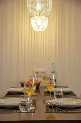 a table with wine glasses and plates and a chandelier at Apartment Sandi in Albufeira