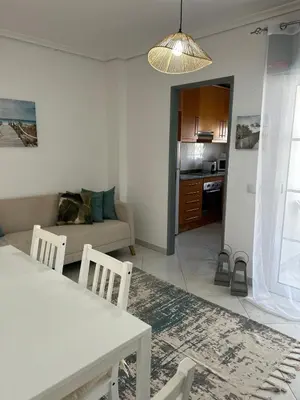 a living room with a table and a couch at La vie simple appartement in Albufeira