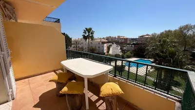 a living room with a couch and a table at Oura View Apartment in Albufeira