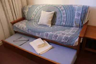 a couch sitting on a table in a room at Recanto de Férias in Albufeira