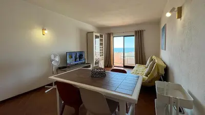 a living room with a couch and a television in it at Apartamento T1 VistaMar Centro Historico Albufeira in Albufeira