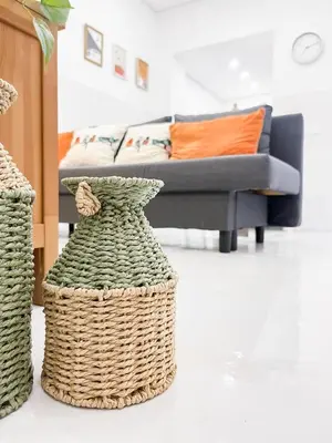 a living room with a couch and two wicker baskets at Casa Melro in Faro