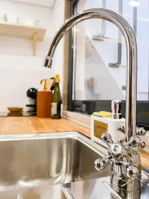 a kitchen sink with a faucet in a kitchen at Casa Melro in Faro