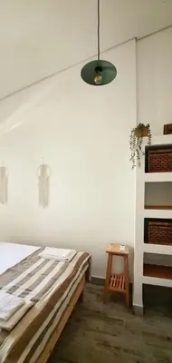 a bedroom with a bed and a pendant light at Casa Melro in Faro