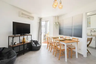 a dining room with a table and chairs and a television at TAC - Bliss Vilamoura in Quarteira