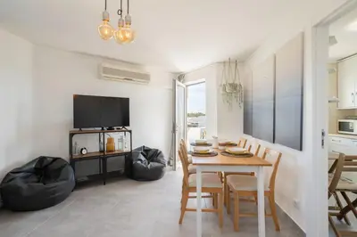 a kitchen and dining room with a table and chairs at TAC - Bliss Vilamoura in Quarteira