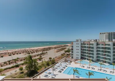 a view of the beach from the balcony of a resort at Dom Pedro Residences in Vilamoura