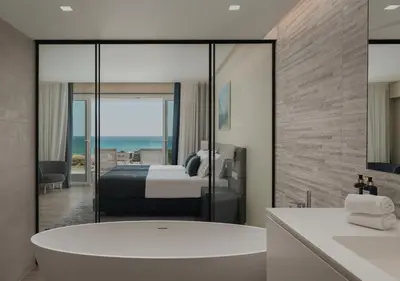 a bathroom with a tub and a bedroom with a bed at Dom Pedro Residences in Vilamoura