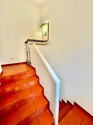a staircase with a mirror on the wall and a stair case at Heart of Quinta do Lago ! in Faro