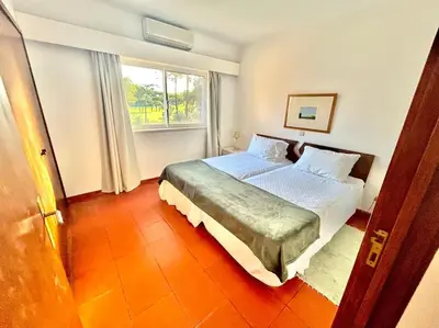 a bedroom with a large bed with a window at Heart of Quinta do Lago ! in Faro