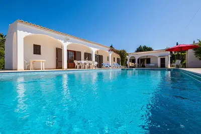 a swimming pool in front of a villa at Villa Brid in Albufeira