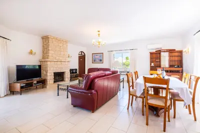 a living room with a couch and a table at Villa Brid in Albufeira