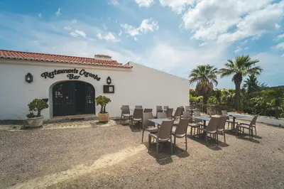 a room with a bed and a tv in a cabin at HolaCamp Albufeira in Albufeira