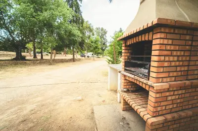 a kitchen and living room with a table and chairs at HolaCamp Albufeira in Albufeira