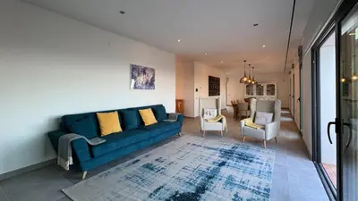 a living room with a couch and chairs and a table at Casa da Cotovia, Loule in Loulé