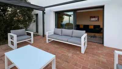 a patio with two white chairs and a couch at Casa da Cotovia, Loule in Loulé