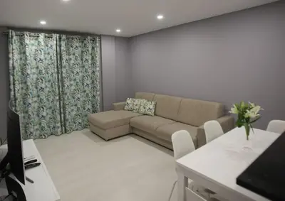 a living room with a couch and a table at Atlantic Pearl by the Sea - Quarteira in Quarteira