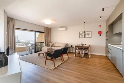 a kitchen and living room with a table and chairs at MILA - Vilamoura in Vilamoura