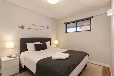 a bedroom with a large bed and a window at MILA - Vilamoura in Vilamoura
