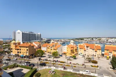 an aerial view of a city with buildings and a harbor at MILA - Vilamoura in Vilamoura