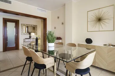 a dining room with a glass table and chairs at BmyGuest - Vilamoura Vila Sol Golf II in Vilamoura
