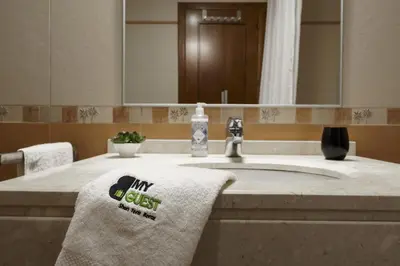a bathroom with a sink with two towels on it at BmyGuest - Vilamoura Vila Sol Golf II in Vilamoura