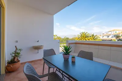 a blue table and chairs on a balcony at Farmvillage Apartment - Free Wifi in Albufeira