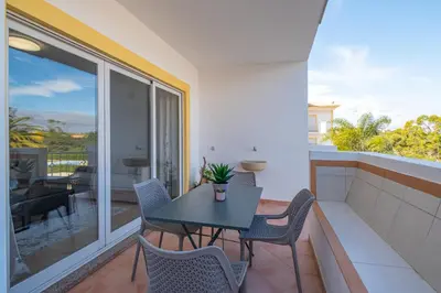 a patio with a table and chairs on a balcony at Farmvillage Apartment - Free Wifi in Albufeira