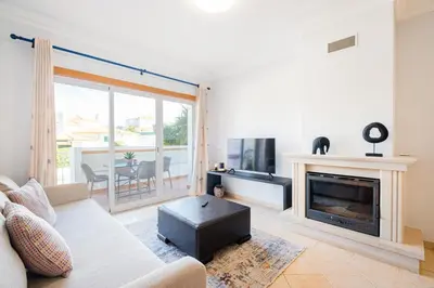 a living room with a couch and a fireplace at Farmvillage Apartment - Free Wifi in Albufeira
