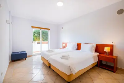 a bedroom with a large white bed and a window at Farmvillage Apartment - Free Wifi in Albufeira