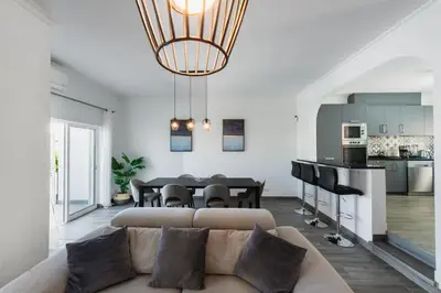 a living room with a couch and a table at Casa Merrigan in Albufeira