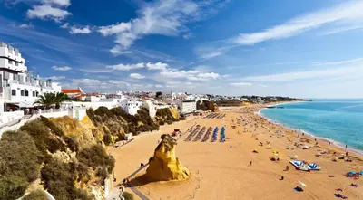 a view of a beach with people and the ocean at Villa Magdalena in Albufeira