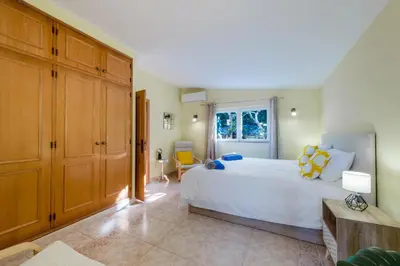 a kitchen with white cabinets and a counter top at Villa Pinheiro in Albufeira